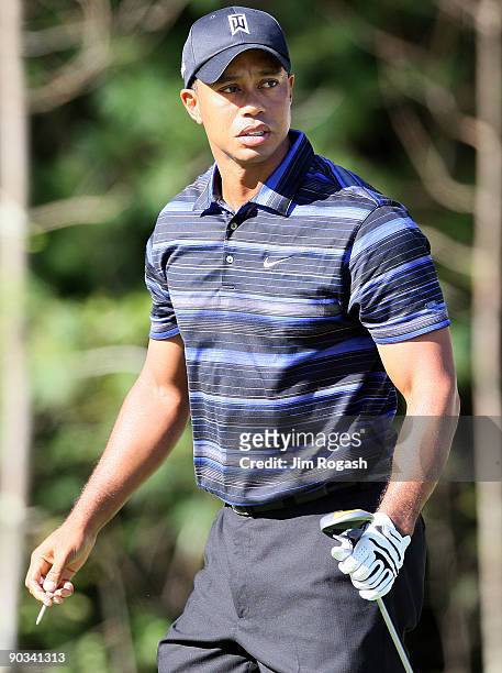Tiger Woods watches the flight of a tee shot during the first round of the Deutsche Bank Championship held at TPC Boston on September 4, 2009 in...