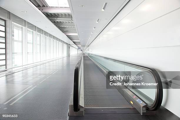 walkway at airport terminal - travolator stock-fotos und bilder