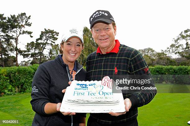 Tom Watson is presented with a birthday cake for his 60th birthday by his junior playing partner Gianna Misenhelter during the first round of the...