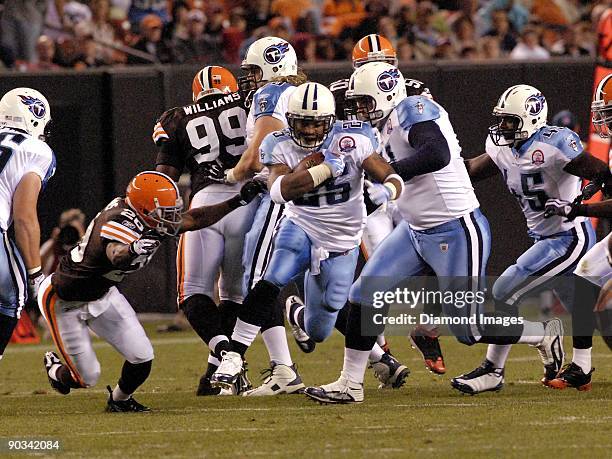 Running back LenDale White of the Tennessee Titans carries the ball as defensive back Mike Adams of the Cleveland Browns tries to stop him during a...