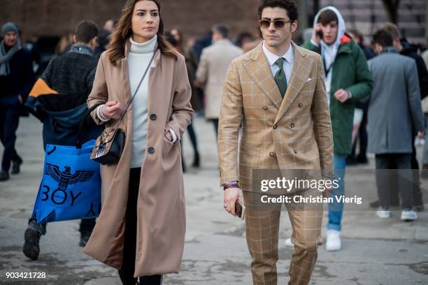 Guests wearing wool coat, beige suit is seen during the 93. Pitti Immagine Uomo at Fortezza Da Basso on January 10, 2018 in Florence, Italy.