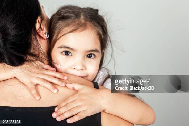 das glückliche kleine mädchen umarmt mom - black jack hand stock-fotos und bilder