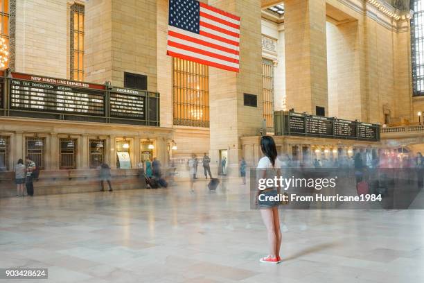 one young lady waiting in grand central station - grand central terminal fotografías e imágenes de stock
