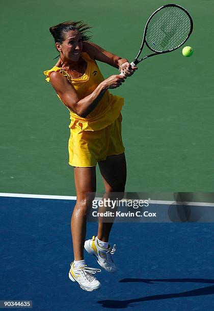 Jelena Jankovic of Serbia returns a shot to Dinara Safina of Russia in the finals of the Western & Southern Financial Group Women's Open on August...