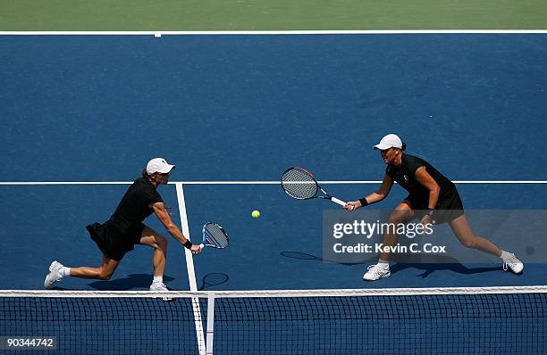 Cara Black of Zimbabwe and Liezel Huber look to play the volley at the net against Nuria Llagostera Vives and Maria Jose Martinez Sanchez, both of...