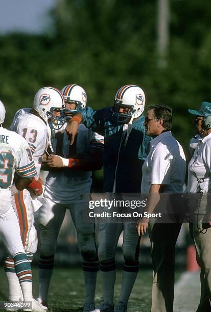 Head Coach Don Shula talks with his quarterback Dan Marino during a time out of an NFL football game circa early 1980's. Shula coached the Dolphins...