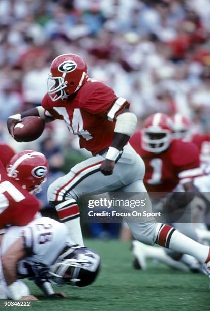 S: Running back Herschel Walker of the Universiy of Georgia Bull Dogs carries the ball against Texas A&M during an early circa 1980's NCAA football...