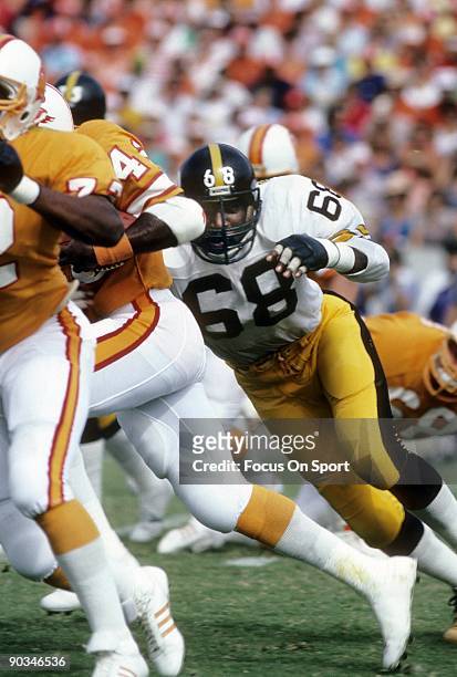 S: Defensive lineman L.C. Greenwood of the Pittsburgh Steelers chases a Tampa Bay Buccaneers runner during a mid circa 1970's NFL football game at...