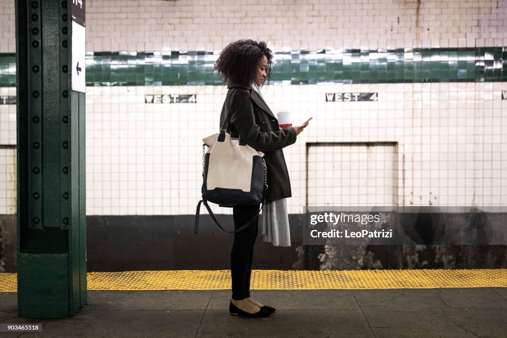 Young woman waiting for the subway train in New York