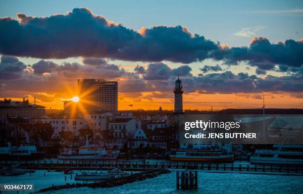 Picture taken on January 5, 2017 at sunset shows a view of the harbour in Rostock-Warnemuende on the Baltic Sea in northeastern Germany. / AFP PHOTO...