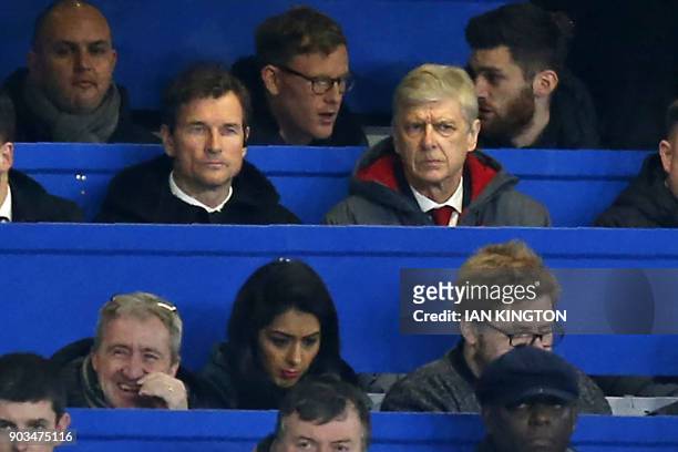 Arsenal's French manager Arsene Wenger sits beside Arsenal's former goalkeeper Jens Lehmann in the press box during the English League Cup semi-final...