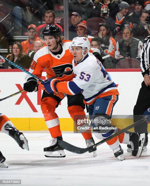 Nolan Patrick of the Philadelphia Flyers battles against Casey Cizikas of the New York Islanders on January 4, 2018 at the Wells Fargo Center in...