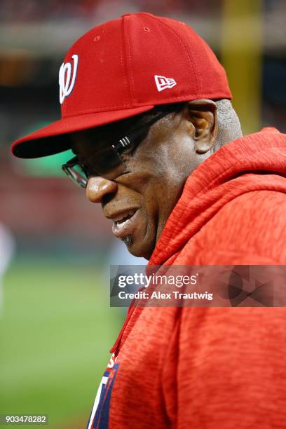 Dusty Baker of the Washington Nationals speaks with a young fan outside the dugout prior to the start of Game 5 of the National League Division...