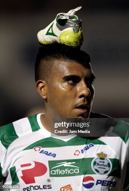 Santos Laguna's player Daniel Luduena celebrates a scored goal against Estudiantes Tecos with a soccer shoe on his head during their match for the...