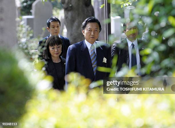 Democratic Party of Japan leader and premier-in-waiting Yukio Hatoyama and his wife Miyuki pray while visiting the Hatoyama family grave site in...