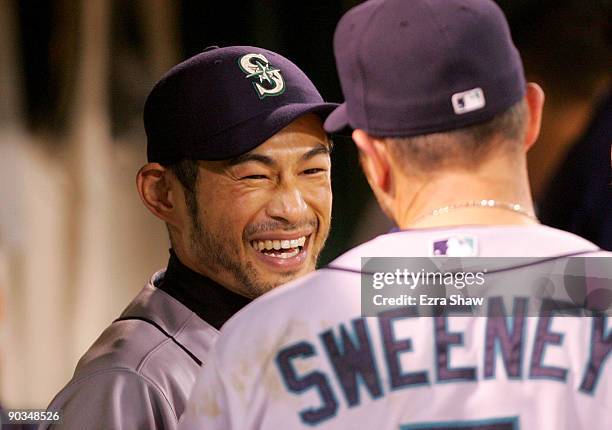 Ichiro Suzuki of the Seattle Mariners jokes with Mike Sweeney in the dugout during their game against the Oakland Athletics at the Oakland Coliseum...