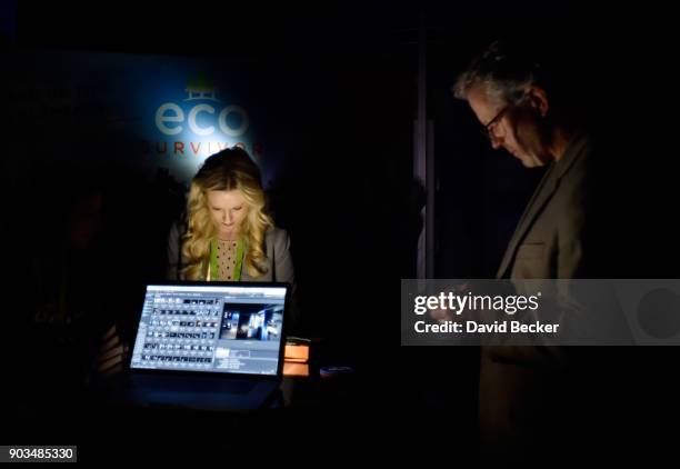 Attendees use the light of their electronic devices at the Jasco Products booth after power was lost during CES 2018 inside the central hall at the...