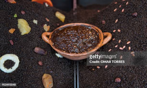 Clay pot with mole sauce is displayed at a stall at the Mole Fair in San Pedro Atocpan, Milpa Alta borough near Mexico City's inner limits on October...