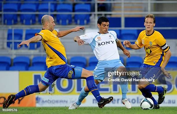 Simon Colosimo of Sydney takes on the Gold Coast defence during the round five A-League match between Gold Coast United and Sydney FC at Skilled Park...