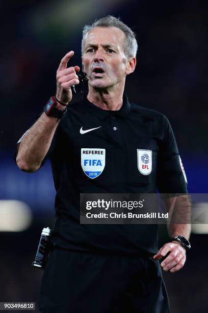 Referee Martin Atkinson gestures during the Carabao Cup Semi-Final First Leg match between Chelsea and Arsenal at Stamford Bridge on January 10, 2018...