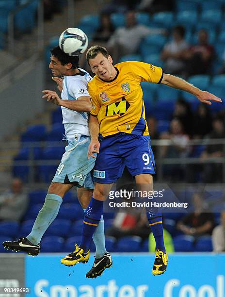 Shane Smeltz of the Gold Coast and Simon Colosimo of Sydney FC compete for the ball during the round five A-League match between Gold Coast United...