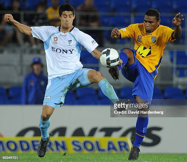 Milson of the Gold Coast and Brendan Gan of Sydney compete for the ball during the round five A-League match between Gold Coast United and Sydney FC...