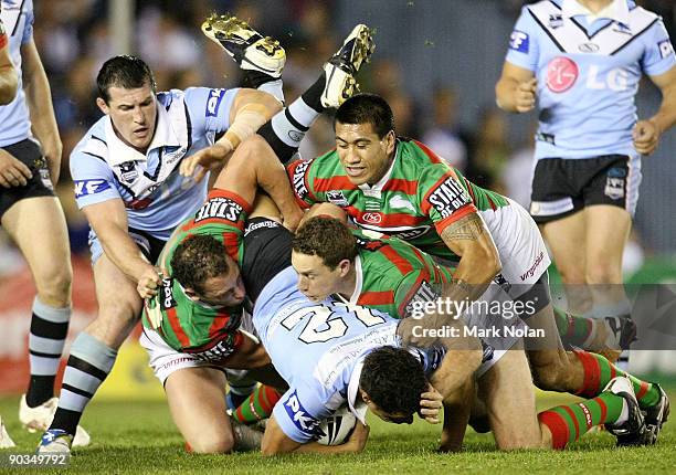 Anthony Tupou of the Sharks is up ended during the round 26 NRL match between the Cronulla Sharks and the South Sydney Rabbitohs at Toyota Stadium on...