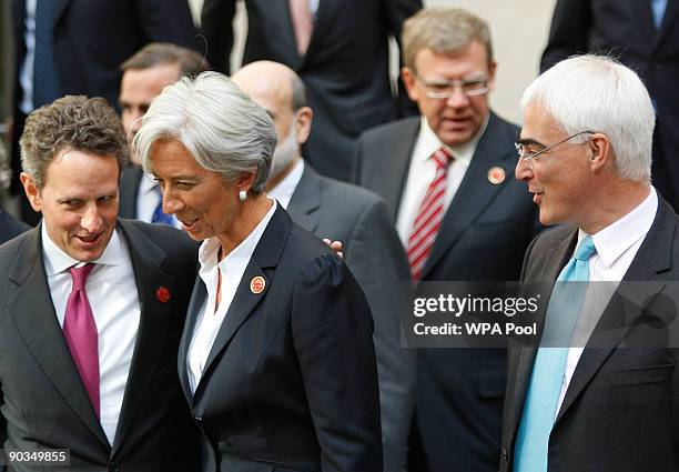 Treasury Secretary Tim Geithner talks to French finance minister Christine Lagarde as Alistair Darling , U.K Chancellor of the Exchequer, looks on...