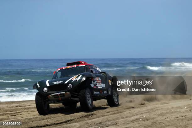 Yazeed Al Rajhi of Saudi Arabia and Mini X-Raid drives with co-driver Timo Gottschalk of Germany in the John Cooper Works Rally Mini car in the...