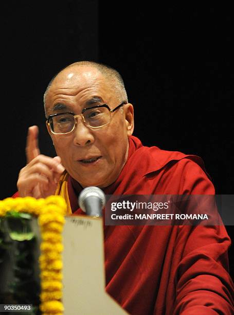 Exiled Tibetan spiritual leader the Dalai Lama gestures as he addresses a conference in Noida, a suburb of New Delhi, on September 5, 2009. The Dalai...