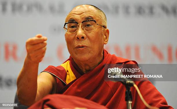 Exiled Tibetan spiritual leader the Dalai Lama gestures as he answers a question following a talk to students in Noida, a suburb of New Delhi, on...