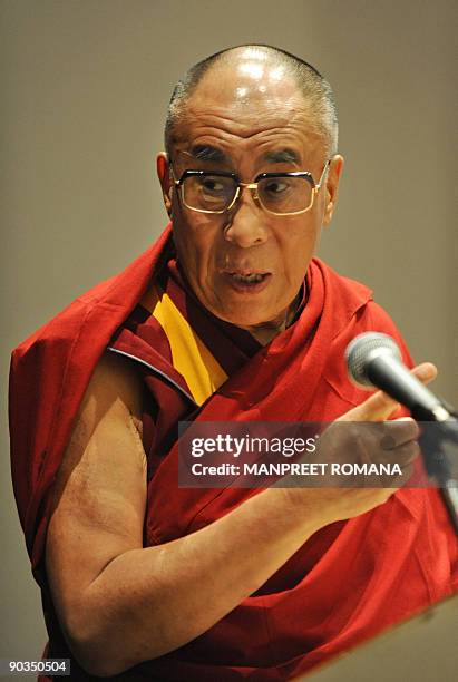 Exiled Tibetan spiritual leader the Dalai Lama gestures as he addresses a conference in Noida, a suburb of New Delhi, on September 5, 2009. The Dalai...