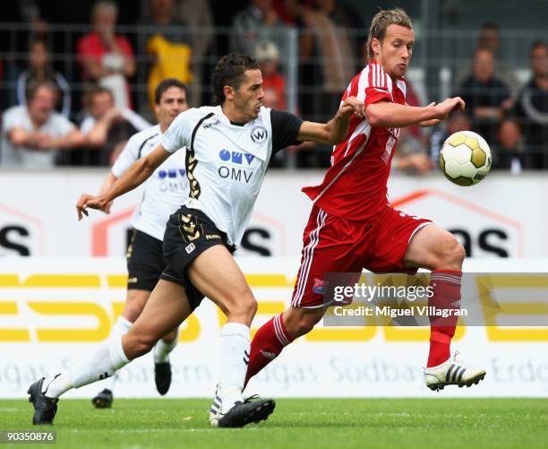 Fikri El Haj Ali of Wacker Burghausen and Manuel Konrad of SpVgg Unterhaching challenge for the ball during the 3. Liga match between Wacker...