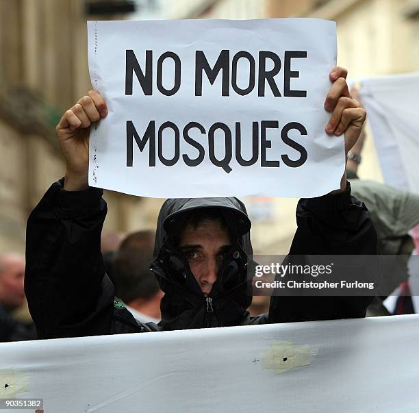 Members of the English Defence League hold make shift signs as they shout towards Police and anti-right wing protesters during a rally on September...