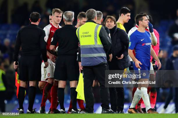 Antonio Conte, Manager of Chelsea talks with Referee Martin Atkinson after the Carabao Cup Semi-Final First Leg match between Chelsea and Arsenal at...