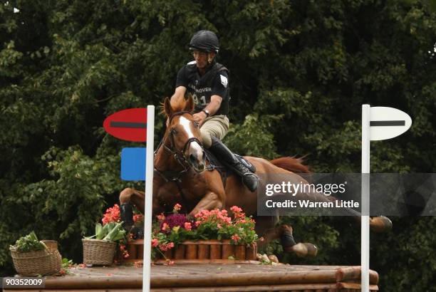 Andrew Nicholson of New Zealand takes a fall ridding Noreo during the cross country event on day three of the Land Rover Burghley Horse Trials on...