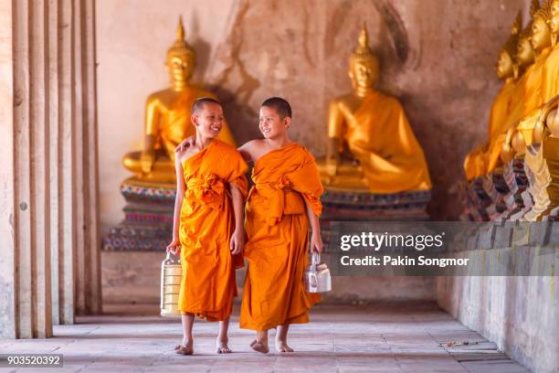 two novices monk walking and talking in old temple - nepal food stock pictures, royalty-free photos & images