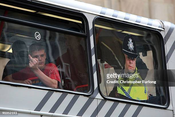 Members of the English Defence League are bussed away from the city center by police Police after clashes with anti-right wing protesters during a...