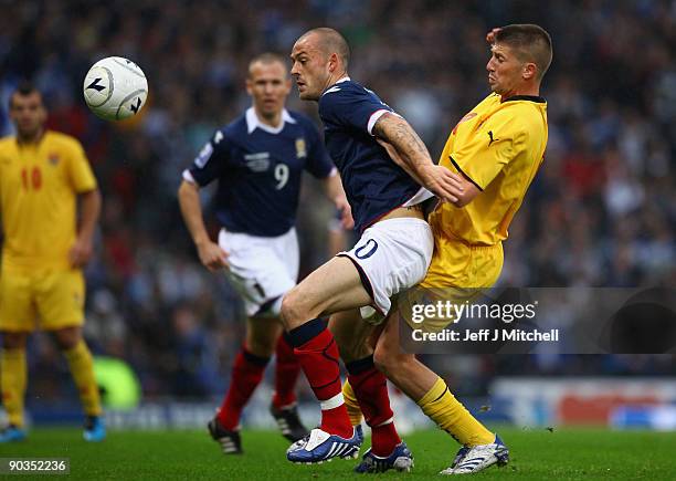 Steven Fletcher of Scotland is tackled by Veliche Shumulikoski of Macedonia during the FIFA 2010 World Cup Qualifier match beteween Scotland and...