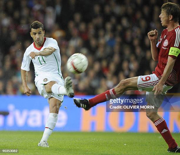 Denmark's Jon Dahl Tomasson struggles for the ball with Portugal's Simao Sabrosa during the FIFA World Cup 2010 qualifying match Denmark vs Portugal...