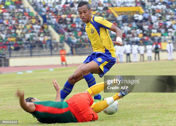 Cameroon's national football team player Benoit Assou duels for the ball with Gabon's national football team player Pierre Emeric Aubame on September...