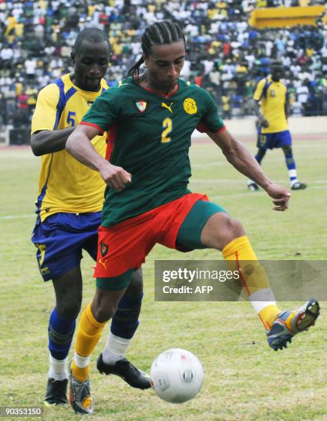 Cameroon's national football team player Benoit Assou Ekotto duels for the ball with Gabon's national football team player Roguy Meye on September 5,...