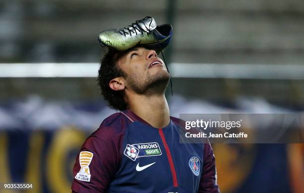 Neymar Jr of PSG celebrates his goal with his Nike shoe on his head during the French League Cup match between Amiens SC and Paris Saint Germain at...