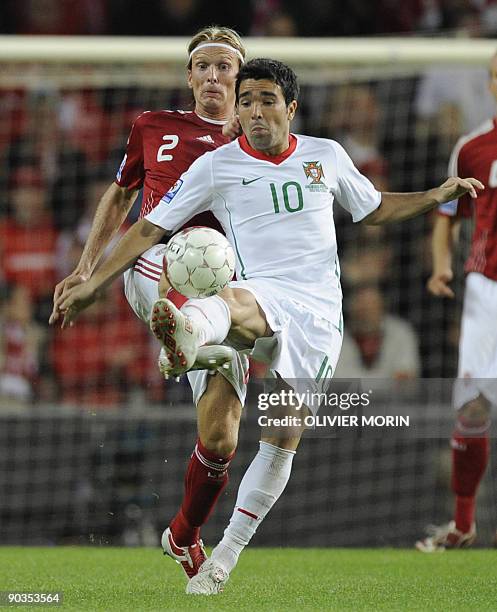 Denmark's Christian Poulsen struggles for the ball with Portugal's Deco during the FIFA World Cup 2010 qualifying match Denmark vs Portugal on...