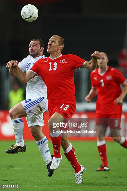 Stephane Grichting of Switzerland challenged by Dimitrios Salpingidis of Greece during the FIFA 2010 World Cup Qualifying Group 2 match between...