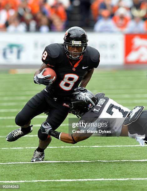 James Rodgers of the Oregon State Beavers avoids the tackle of Tracy Ford of the Portland State Vikings in the second quarter of the game at Reser...