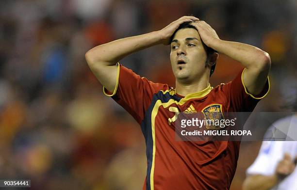Spain's forward David Villa reacts after missing a penalti shot against Belgium during their World Cup 2010 qualifier football match at the Riazor...