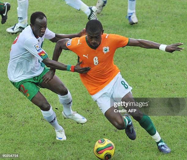 Salomon Kalou of 'The Elephants', the Ivory Coast's national football team vies with Saidou Madi Panandetiguiri of Burkina Faso on September 5, 2009...