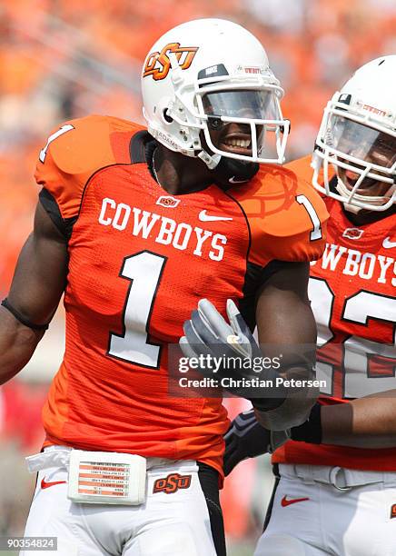 Wide receiver Dez Bryant of the Oklahoma State Cowboys celebrates his touchdown with teammate Dexter Pratt during the second quarter of the game...