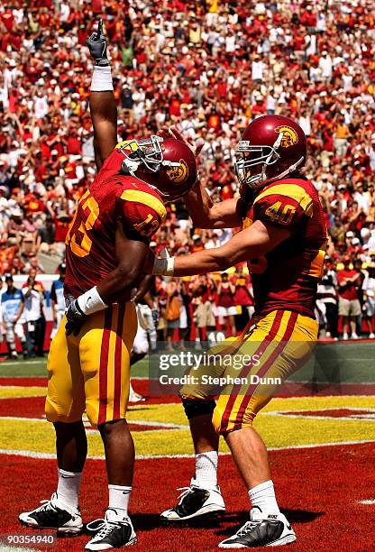 Running back Stafon Johnson of the USC Trojans celebrates with tight end Rhett Ellison after scoring the Trojans' first touchdown against the San...